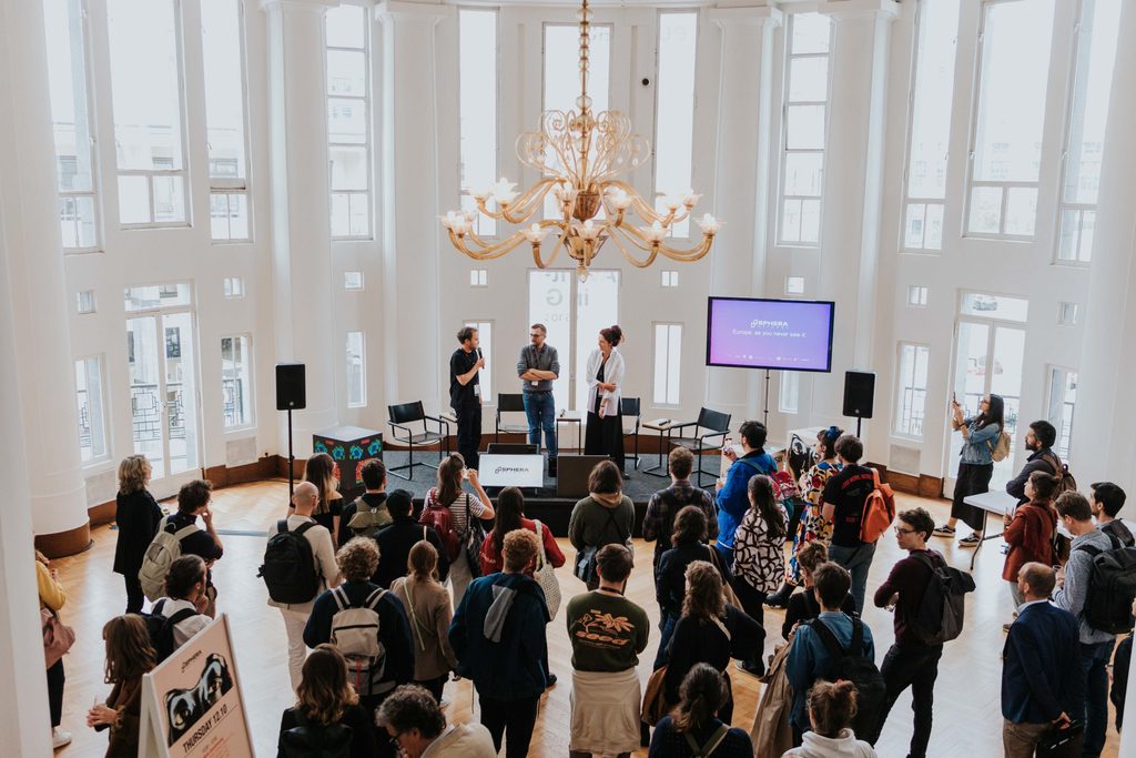 Photo of an assembly before three people presenting Sphera Network