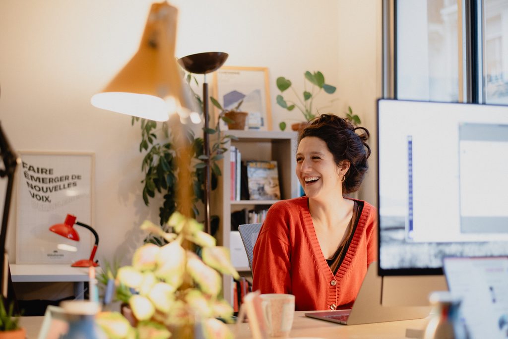Francesca Fresta smiling in her workplace, surrounded with plants