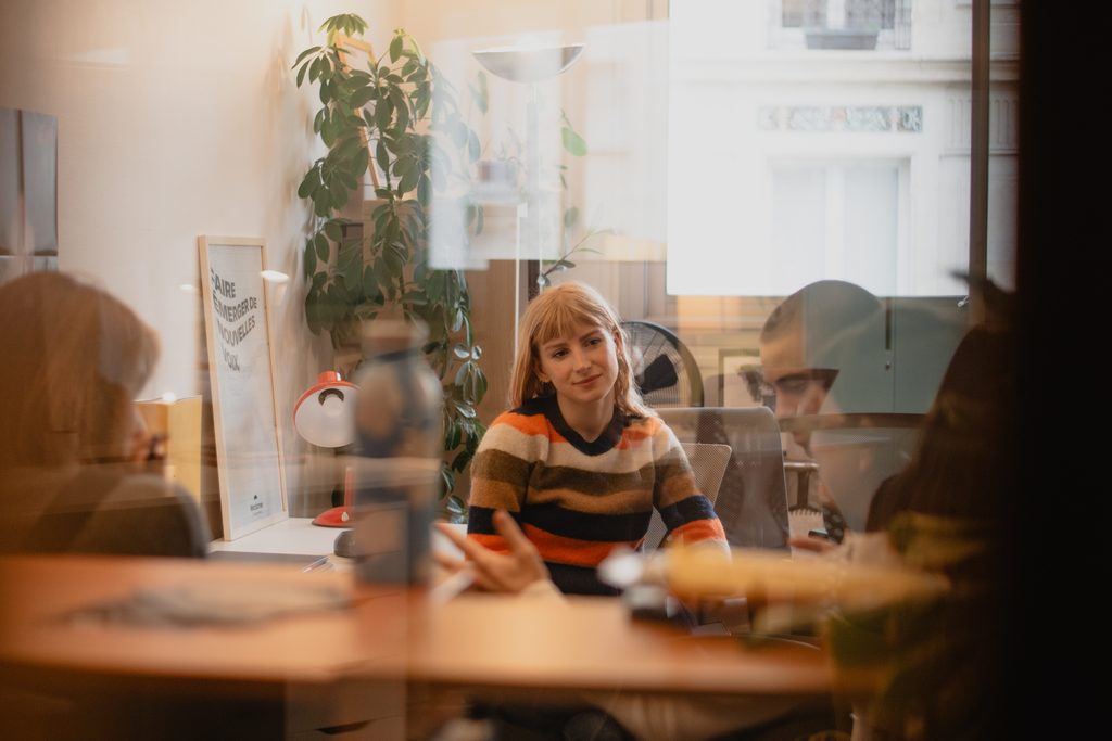 Meredith Ruleman, content creator at Sphera, and three other persons around her, working in an office